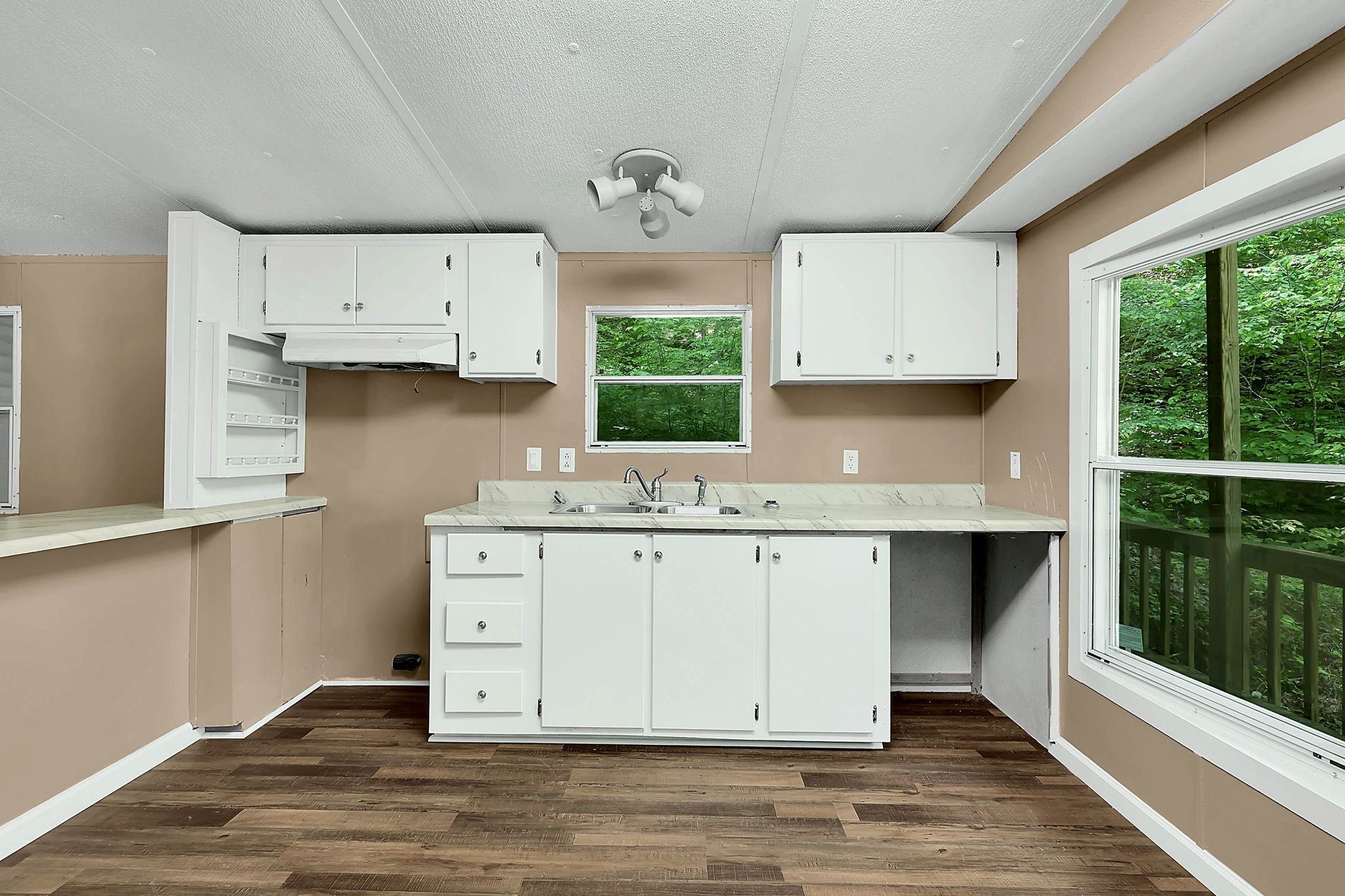 660 Rogues Fork Road Bethpage, TN 37022 - Photo 18 of 55 a kitchen with granite countertop white cabinets a window a sink and a stove