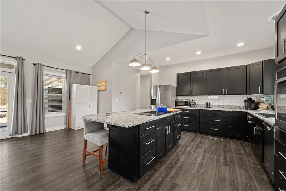 212 Winding Lane Seneca, SC 29672 - Photo 3 of 47 This contemporary kitchen features high ceilings, an expansive island, and ample cabinetry for stylish living.