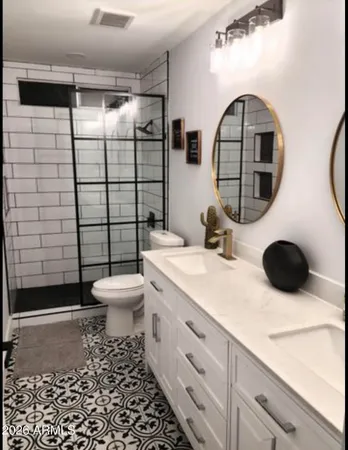 a bathroom with a toilet a sink and mirror