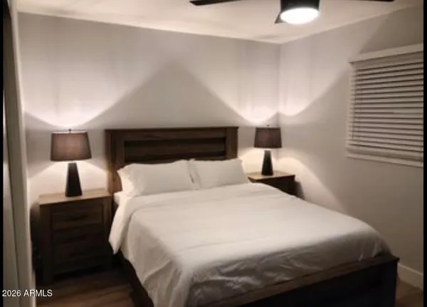 a bedroom with a bed and a night stand