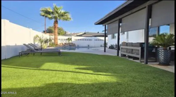 a view of a backyard with plants and a patio