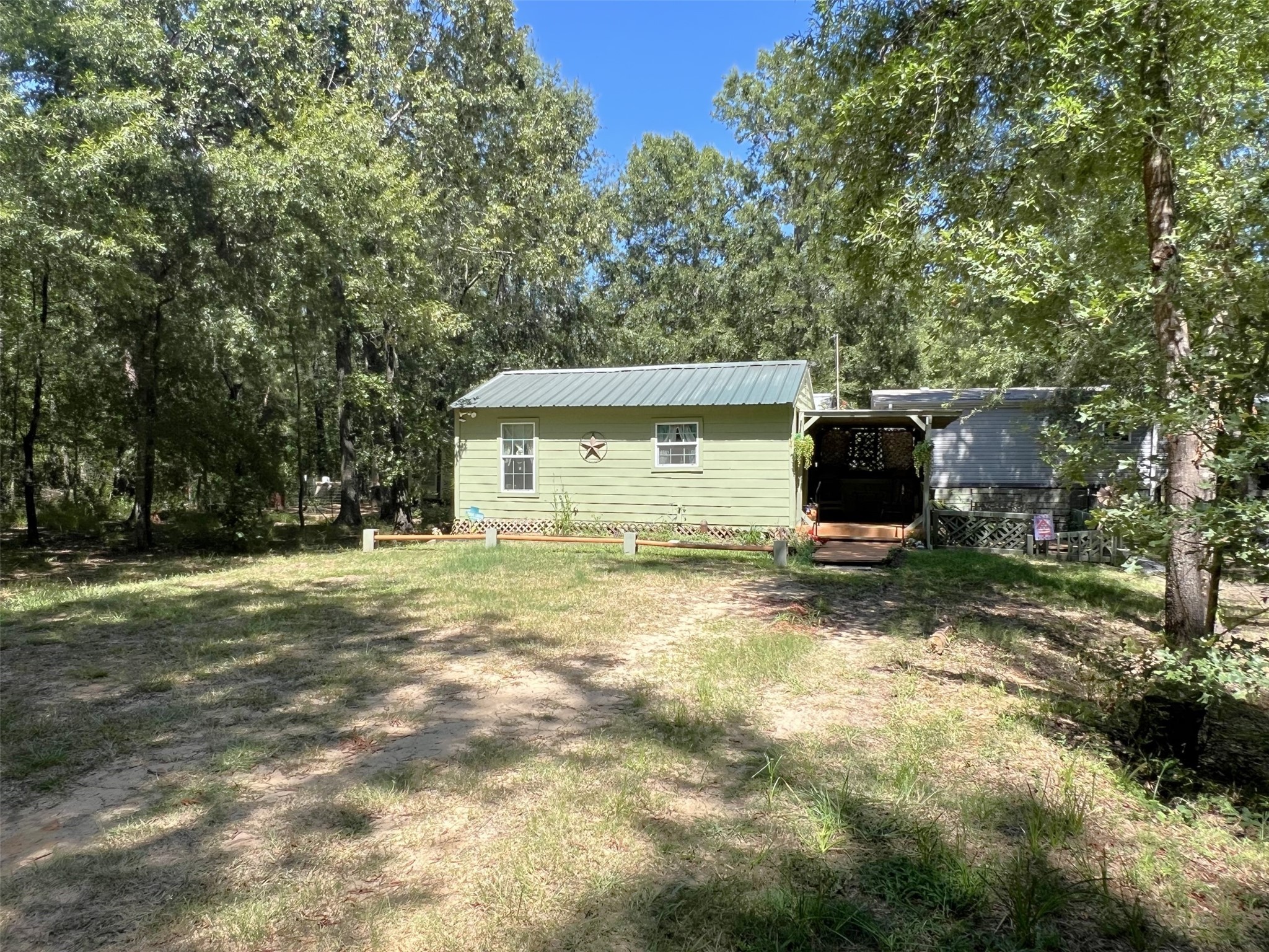 204 Knottypine Livingston, TX 77351 - Photo 5 of 30 a backyard of a house with barbeque oven and outdoor seating