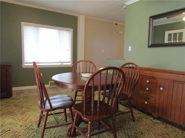 a view of a dining room with furniture and window