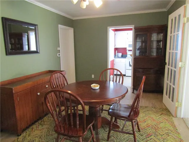 a view of a dining room with furniture and window