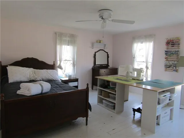 a kitchen with a table chairs and white cabinets