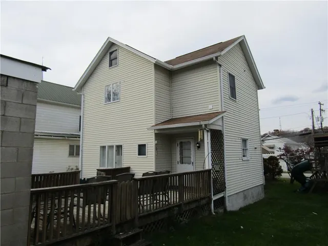 a view of a house with wooden deck