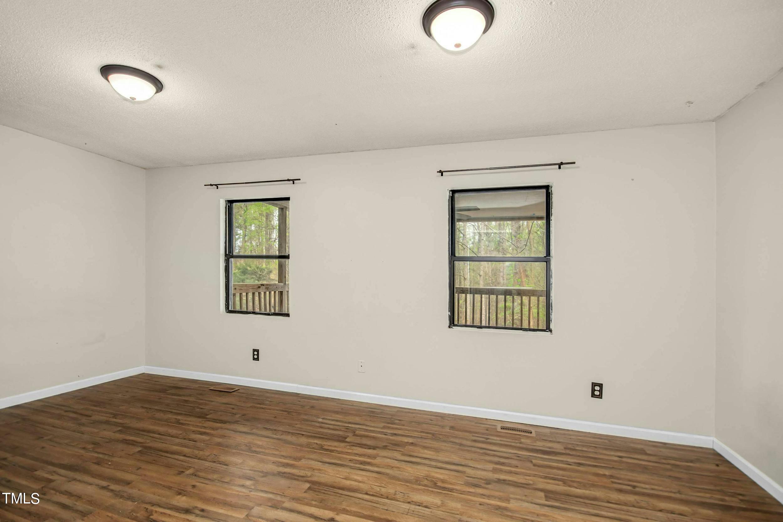 2609 Carpenter Pond Road Raleigh, NC 27613 - Photo 12 of 33 wooden floor in an empty room with a window