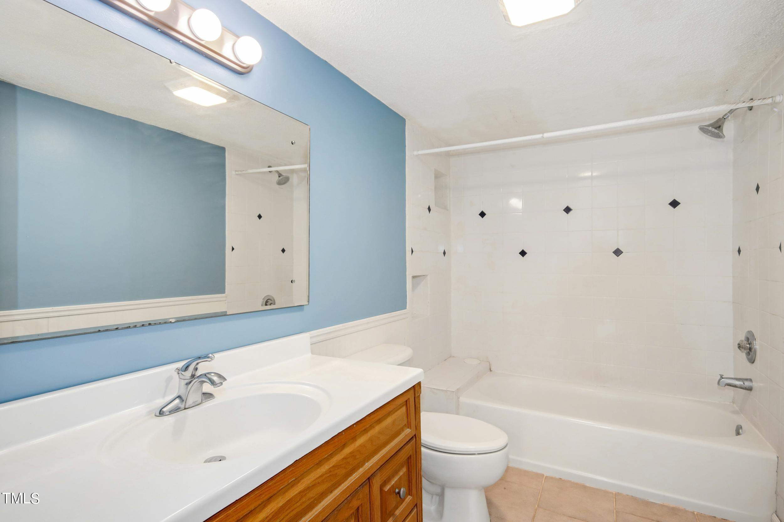 2609 Carpenter Pond Road Raleigh, NC 27613 - Photo 16 of 33 a bathroom with a sink a toilet and a bathtub