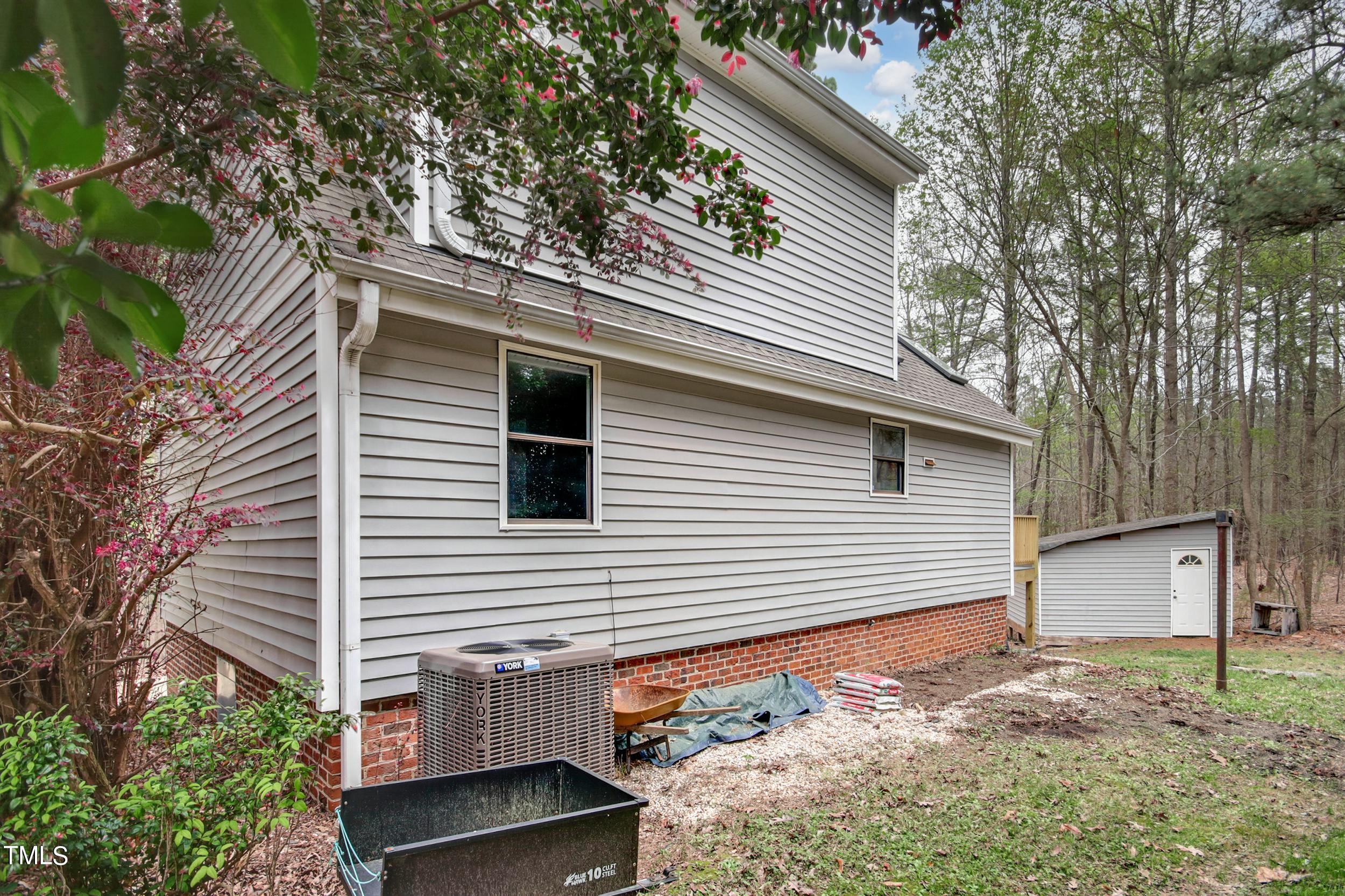 2609 Carpenter Pond Road Raleigh, NC 27613 - Photo 31 of 33 a view of a house with a yard