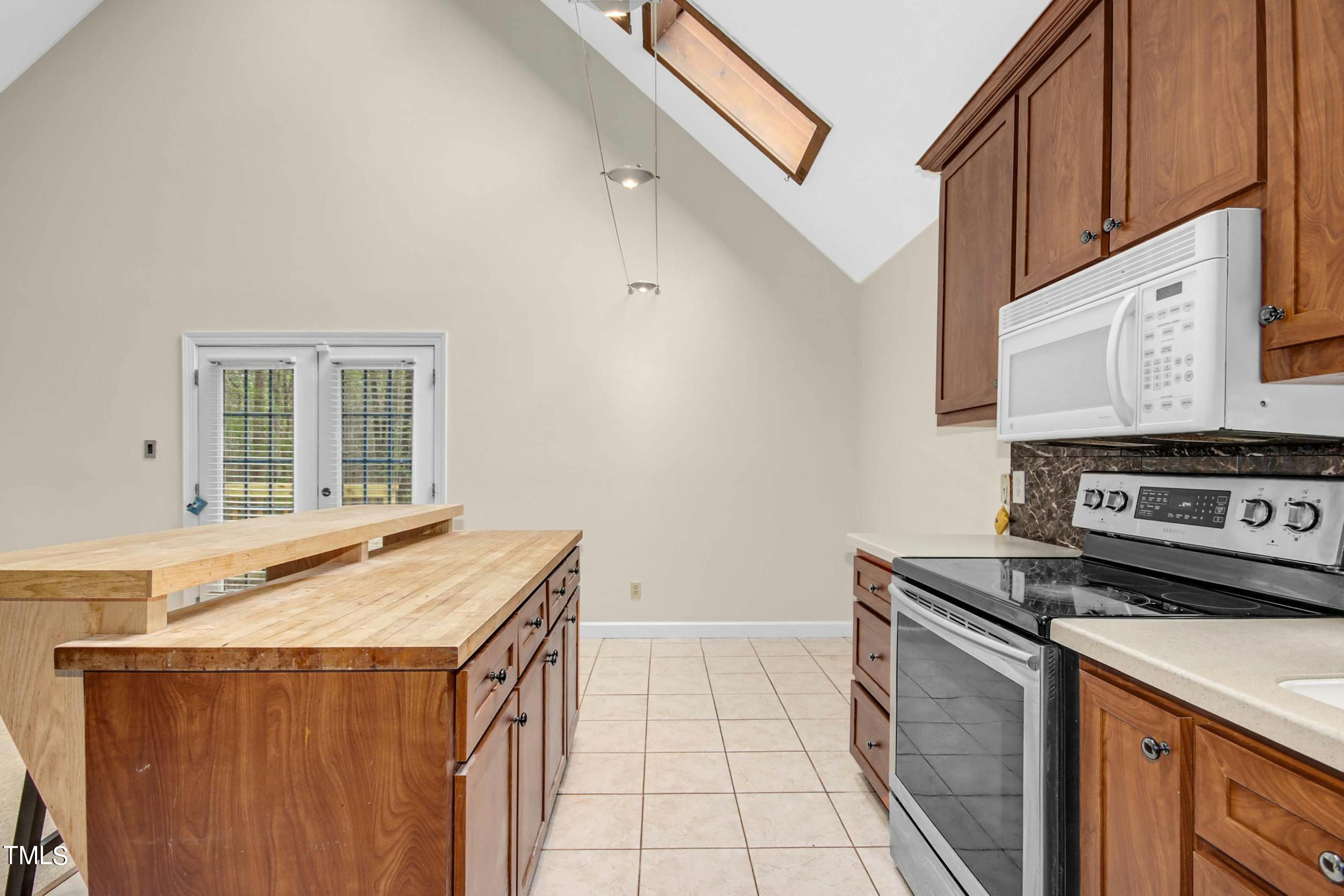 2609 Carpenter Pond Road Raleigh, NC 27613 - Photo 10 of 33 a kitchen with a stove and a sink