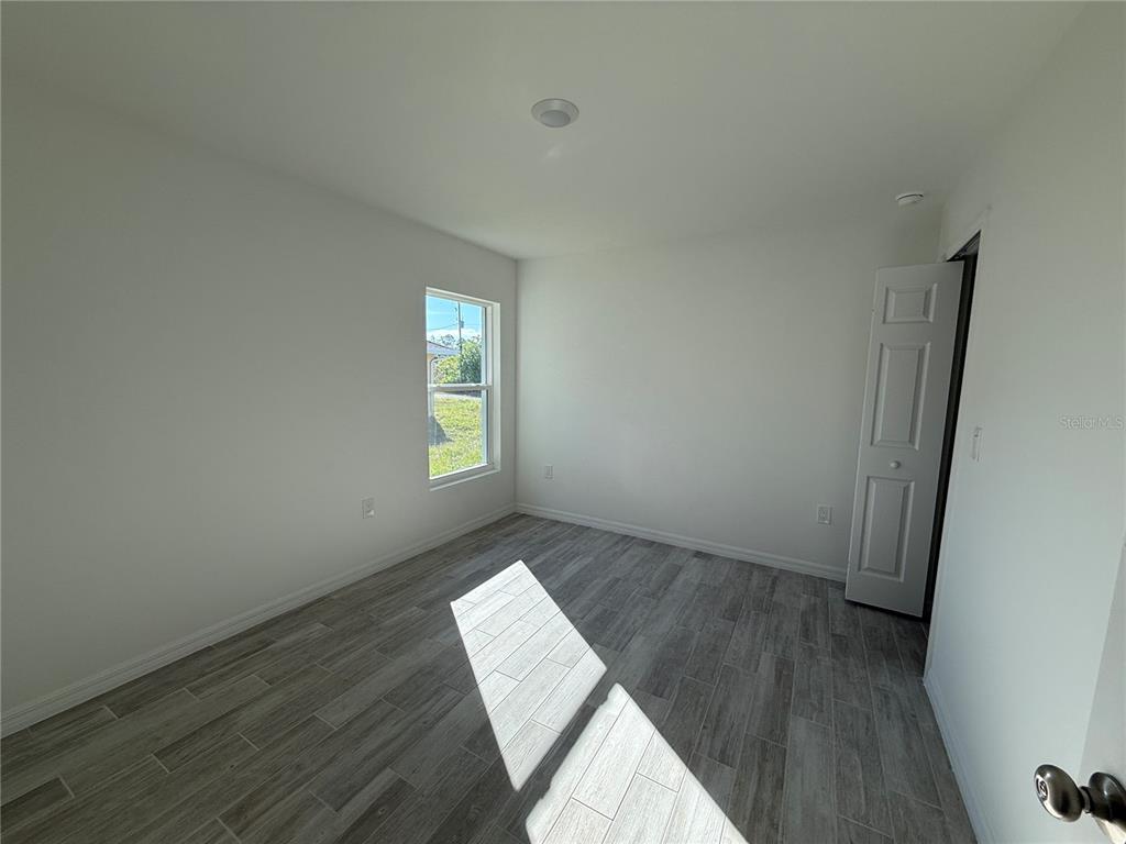 5290 Arley Road North Port, FL 34288 - Photo 14 of 26 a view of wooden floor and windows in a room