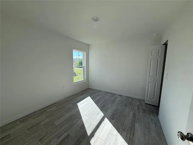 a view of wooden floor and windows in a room