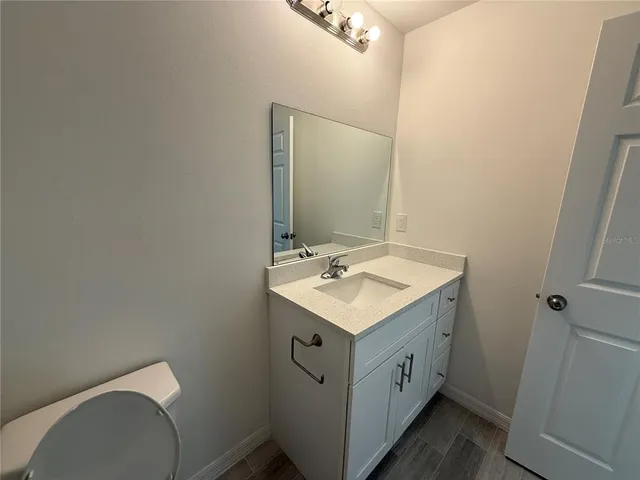 a view of bathroom with a sink and a mirror