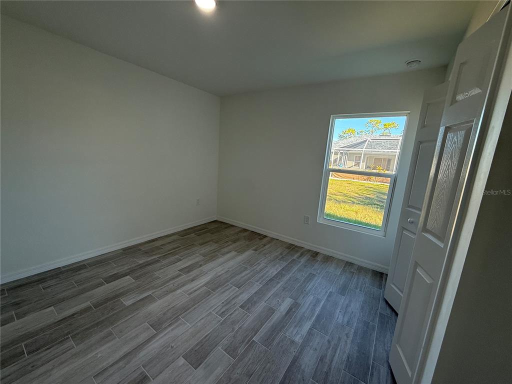 5290 Arley Road North Port, FL 34288 - Photo 17 of 26 a view of empty room with wooden floor and fan