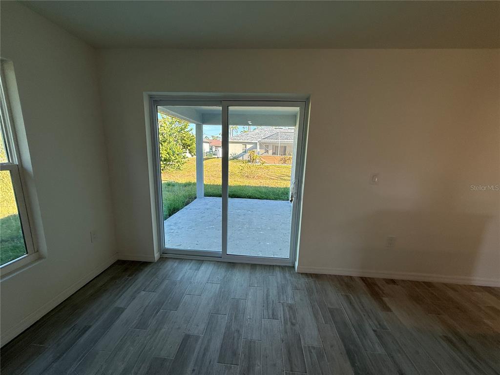 5290 Arley Road North Port, FL 34288 - Photo 20 of 26 an empty room with wooden floor and windows