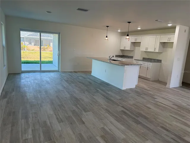 a large kitchen with stainless steel appliances kitchen island a large counter space and a window