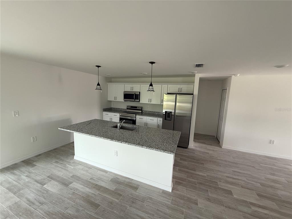 5290 Arley Road North Port, FL 34288 - Photo 5 of 26 a kitchen with stainless steel appliances granite countertop a sink a stove and a refrigerator