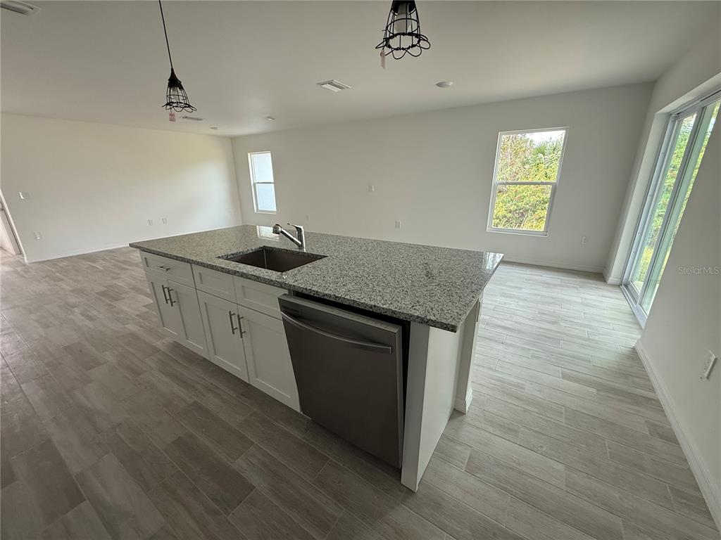 5290 Arley Road North Port, FL 34288 - Photo 8 of 26 a kitchen with granite countertop a sink and a hard wood floor
