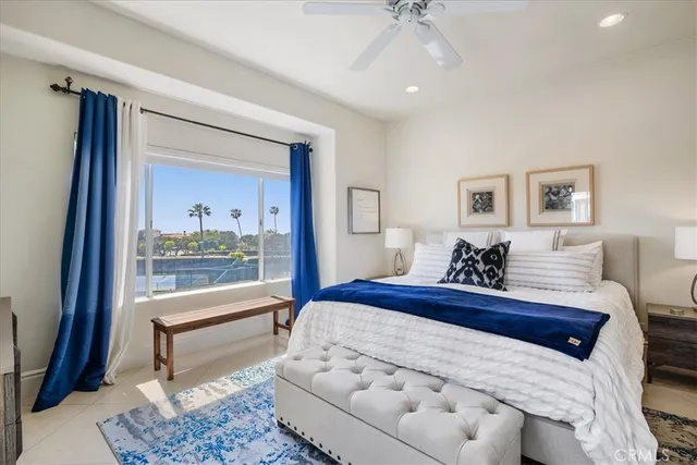 a bedroom with a large bed and a chandelier