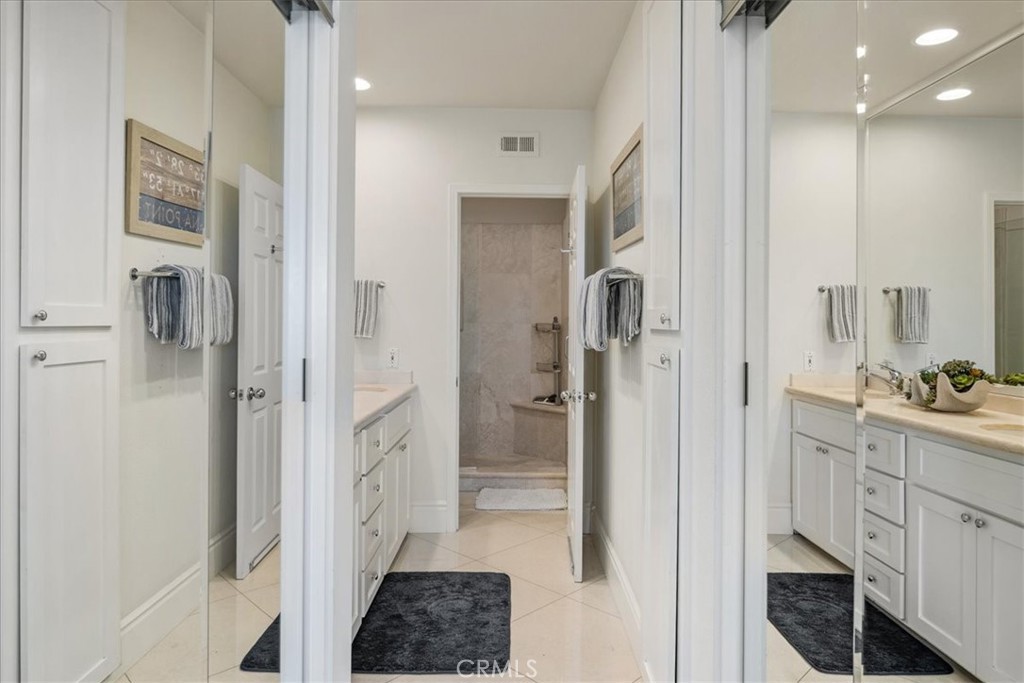 17 Centre Court Dana Point, CA 92629 - Photo 20 of 45 a bathroom with a double vanity sink a toilet and shower
