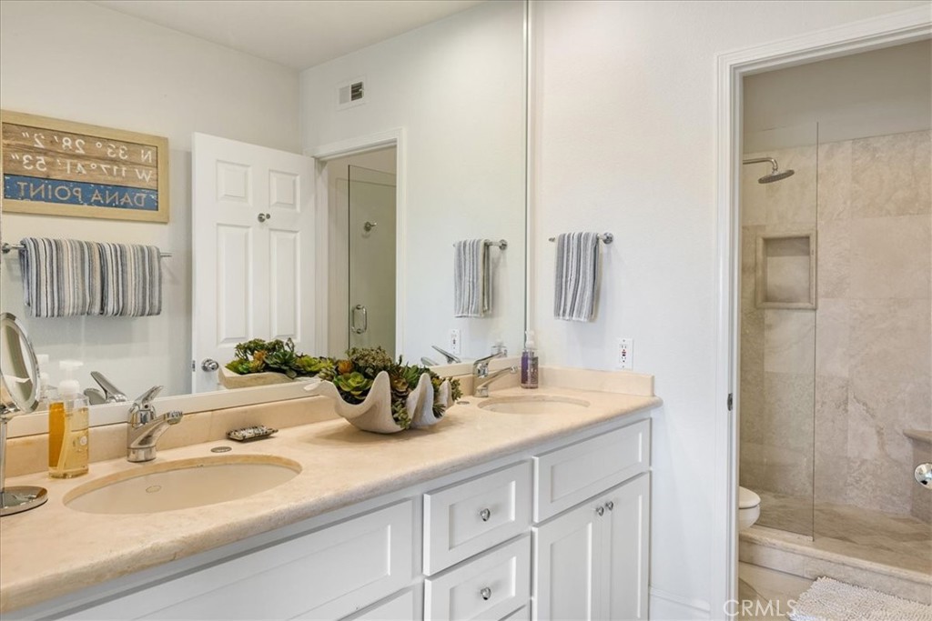 17 Centre Court Dana Point, CA 92629 - Photo 21 of 45 a bathroom with double sink and a mirror