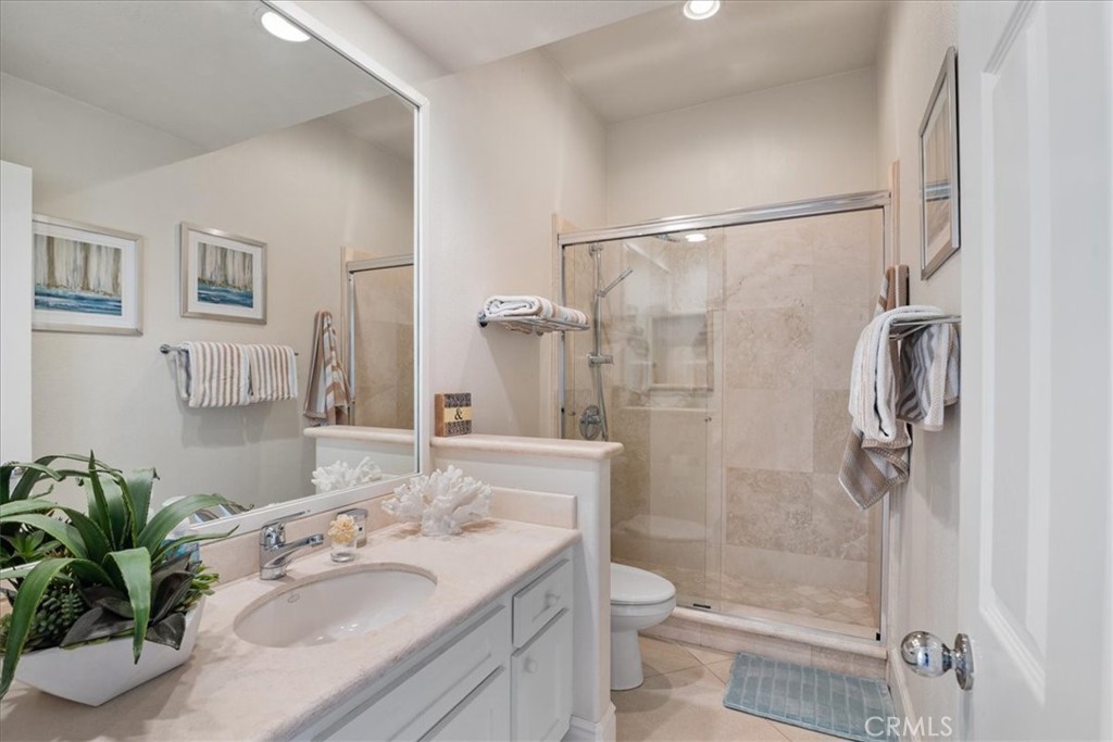 17 Centre Court Dana Point, CA 92629 - Photo 24 of 45 a bathroom with a granite countertop sink toilet a large mirror a shower and a bathroom