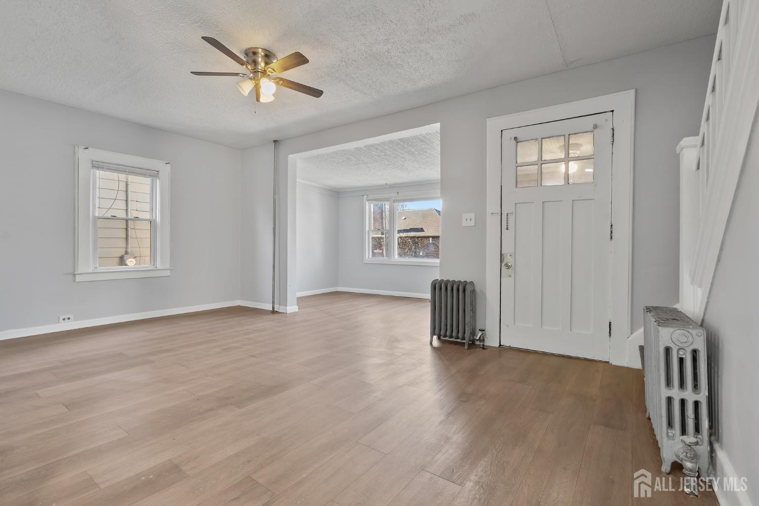 83 May Street Irvington, NJ 07111 - Photo 14 of 27 wooden floor in an empty room with a window