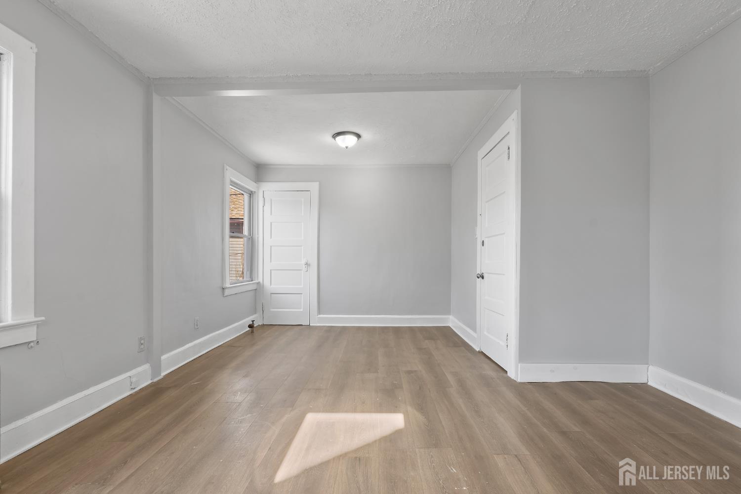 83 May Street Irvington, NJ 07111 - Photo 22 of 27 a view of an empty room with wooden floor