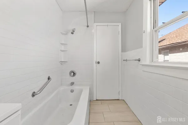a bathroom with a bathtub and shower