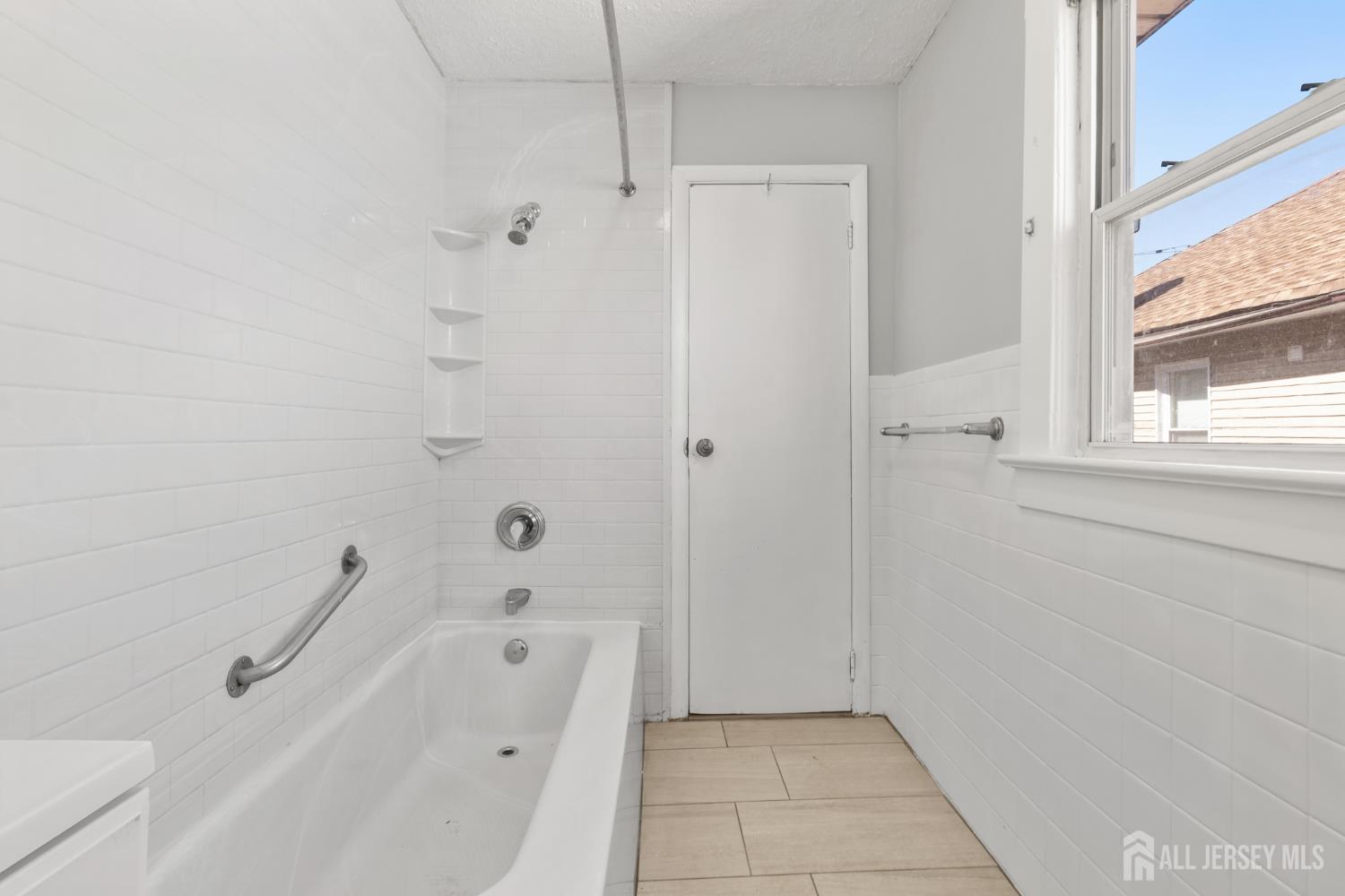 83 May Street Irvington, NJ 07111 - Photo 23 of 27 a bathroom with a bathtub and shower