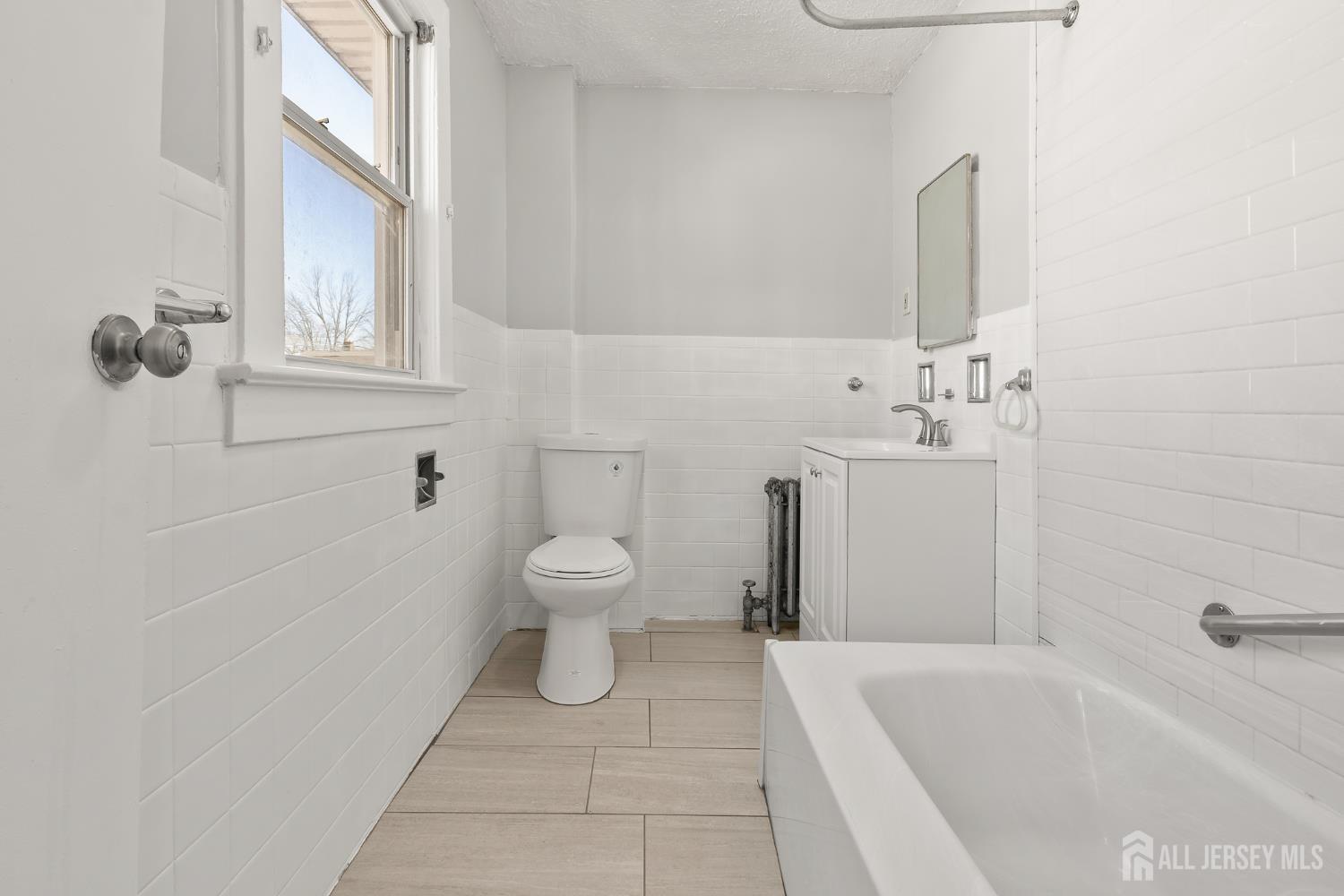 83 May Street Irvington, NJ 07111 - Photo 25 of 27 a bathroom with a toilet sink and shower