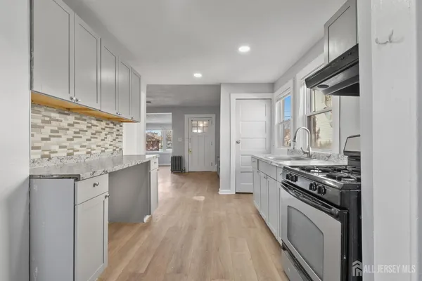 a kitchen with stainless steel appliances granite countertop a stove and a refrigerator