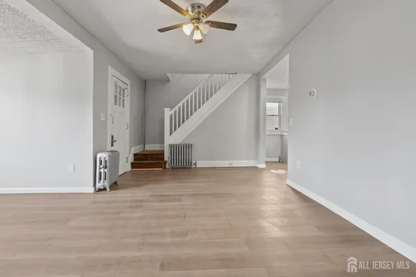 a view of an empty room with stairs