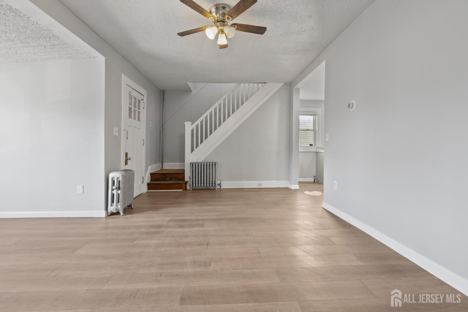 83 May Street Irvington, NJ 07111 - Photo 10 of 27 a view of an empty room with stairs