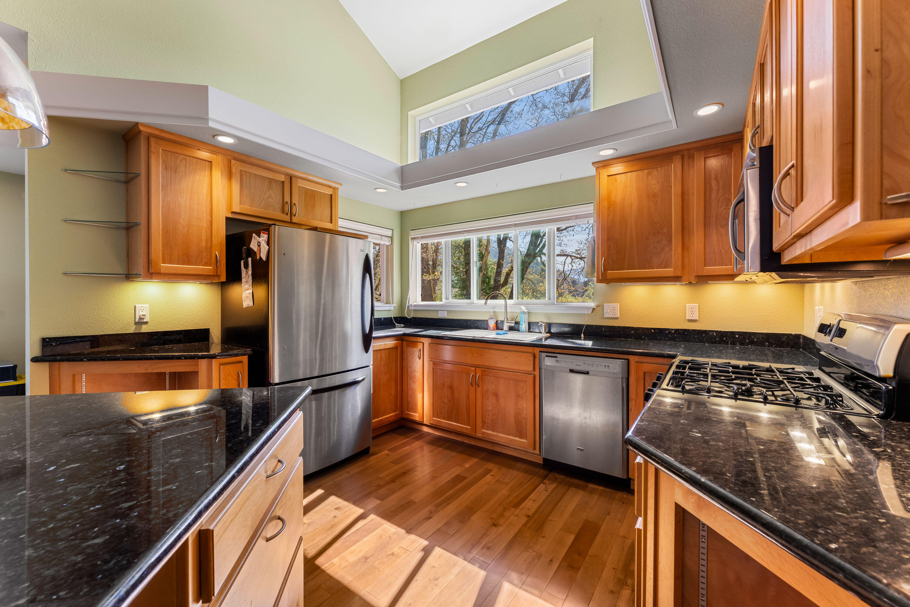 105 Cedar Ridge Terrace Rogue River, OR 97537 - Photo 4 of 23 a kitchen with granite countertop stainless steel appliances and wooden cabinets