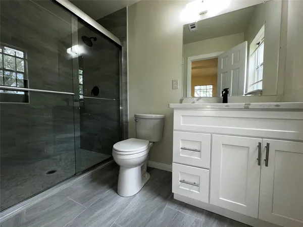 a bathroom with a toilet sink and shower