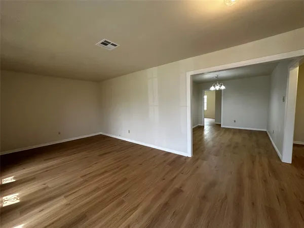 a view of a room with wooden floor and windows
