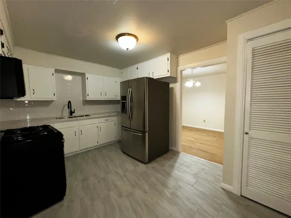 a kitchen with a refrigerator and a sink