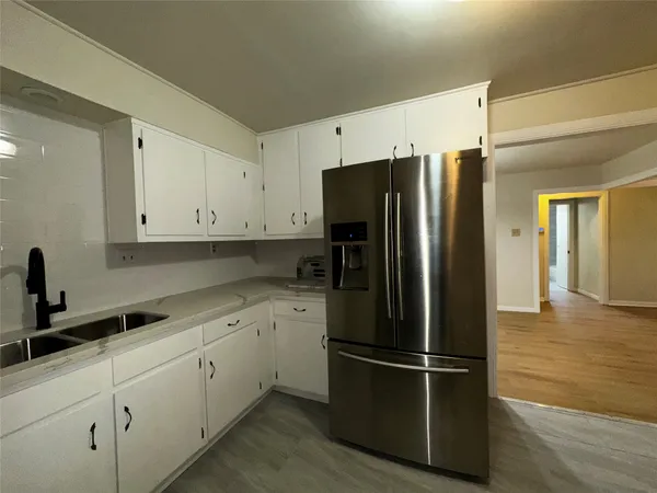 a kitchen with stainless steel appliances a refrigerator sink and cabinets