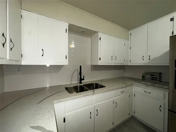 a kitchen with a sink and cabinets