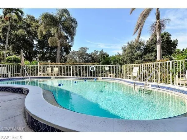 a view of a swimming pool with a outdoor seating