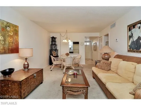 a living room with furniture and a lamp