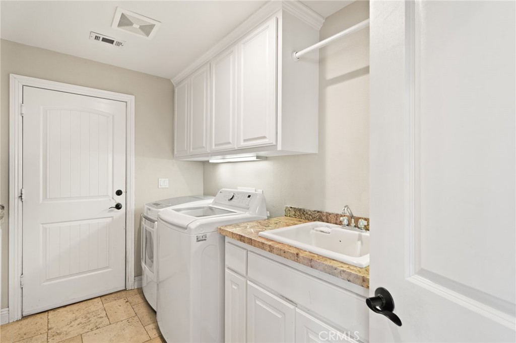 38136 Butterfly Court Yucaipa, CA 92399 - Photo 42 of 71 a view of a utility room with sink dryer and washer