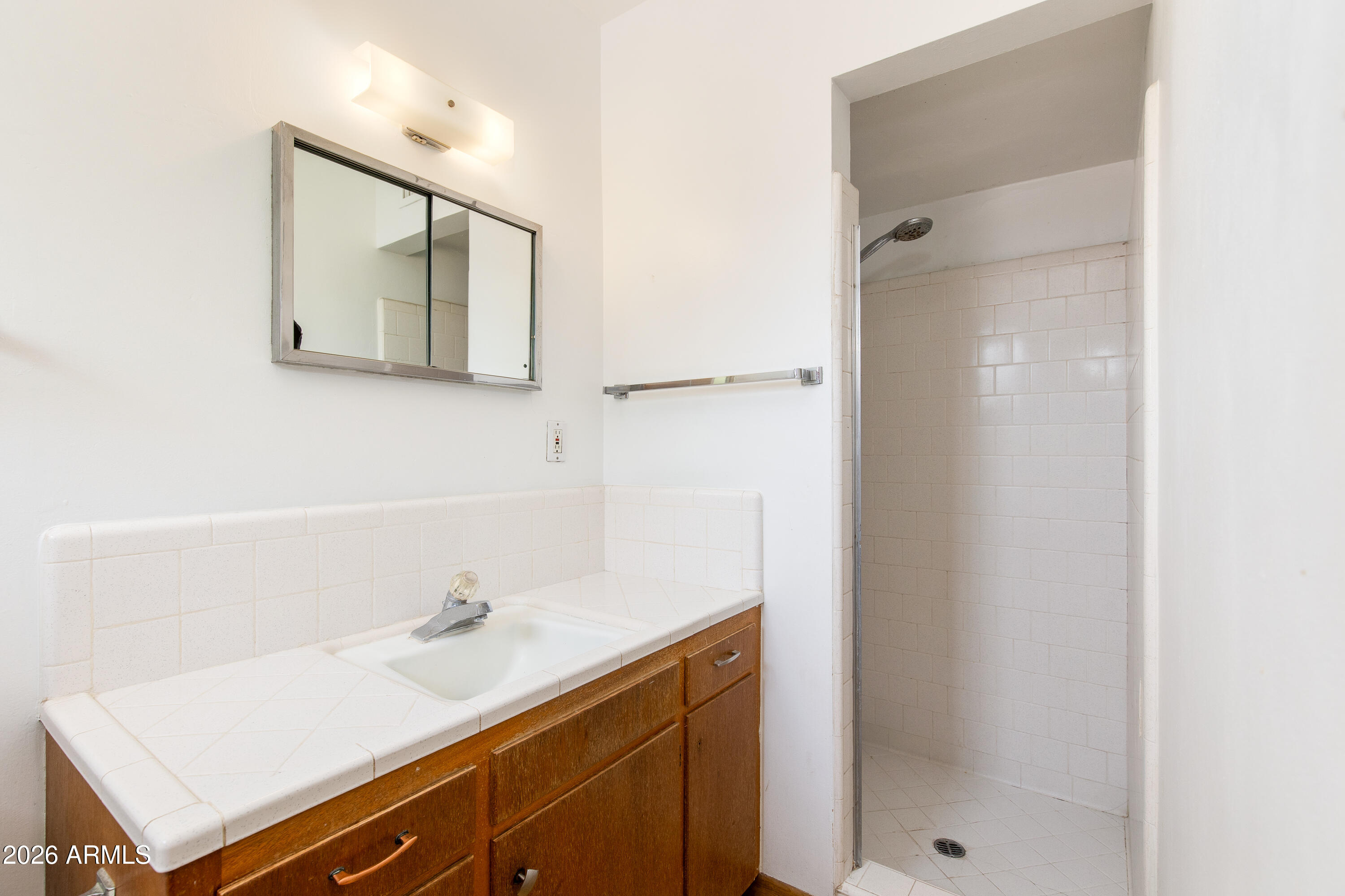 1524 West Ocotillo Road Phoenix, AZ 85015 - Photo 17 of 29 a bathroom with a sink and a mirror