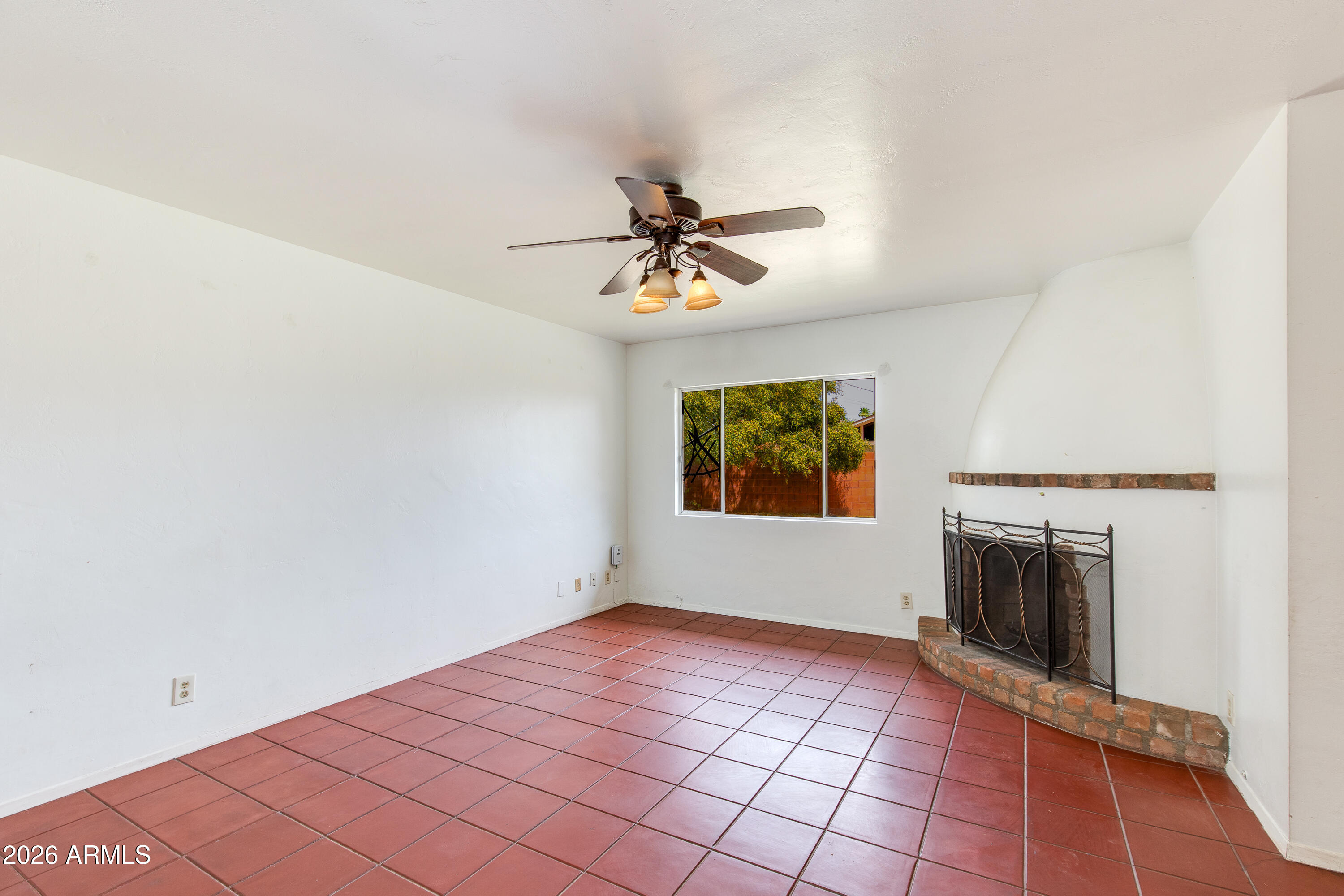 1524 West Ocotillo Road Phoenix, AZ 85015 - Photo 7 of 29 a view of a livingroom with a fireplace and a chandelier fan