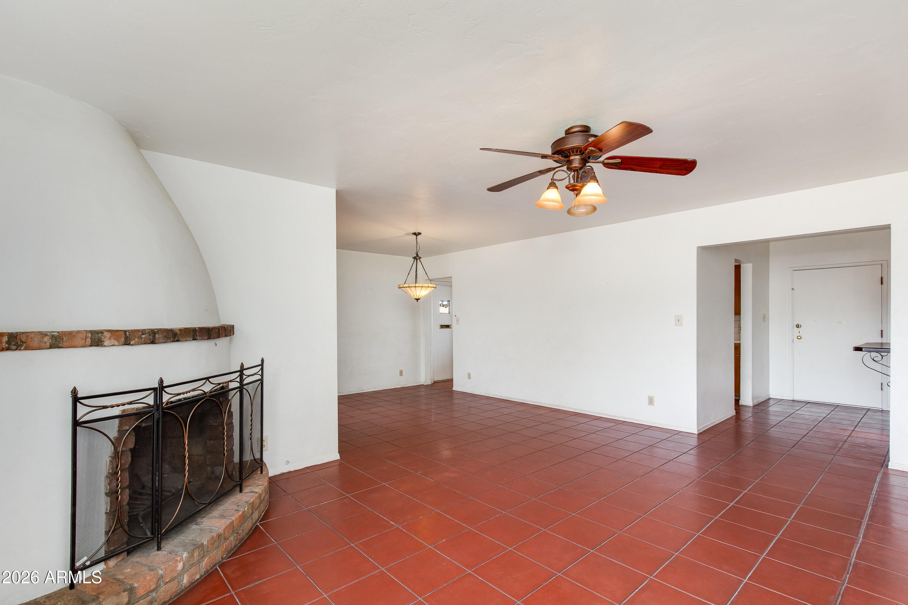 1524 West Ocotillo Road Phoenix, AZ 85015 - Photo 8 of 29 an empty room with fan and kitchen view