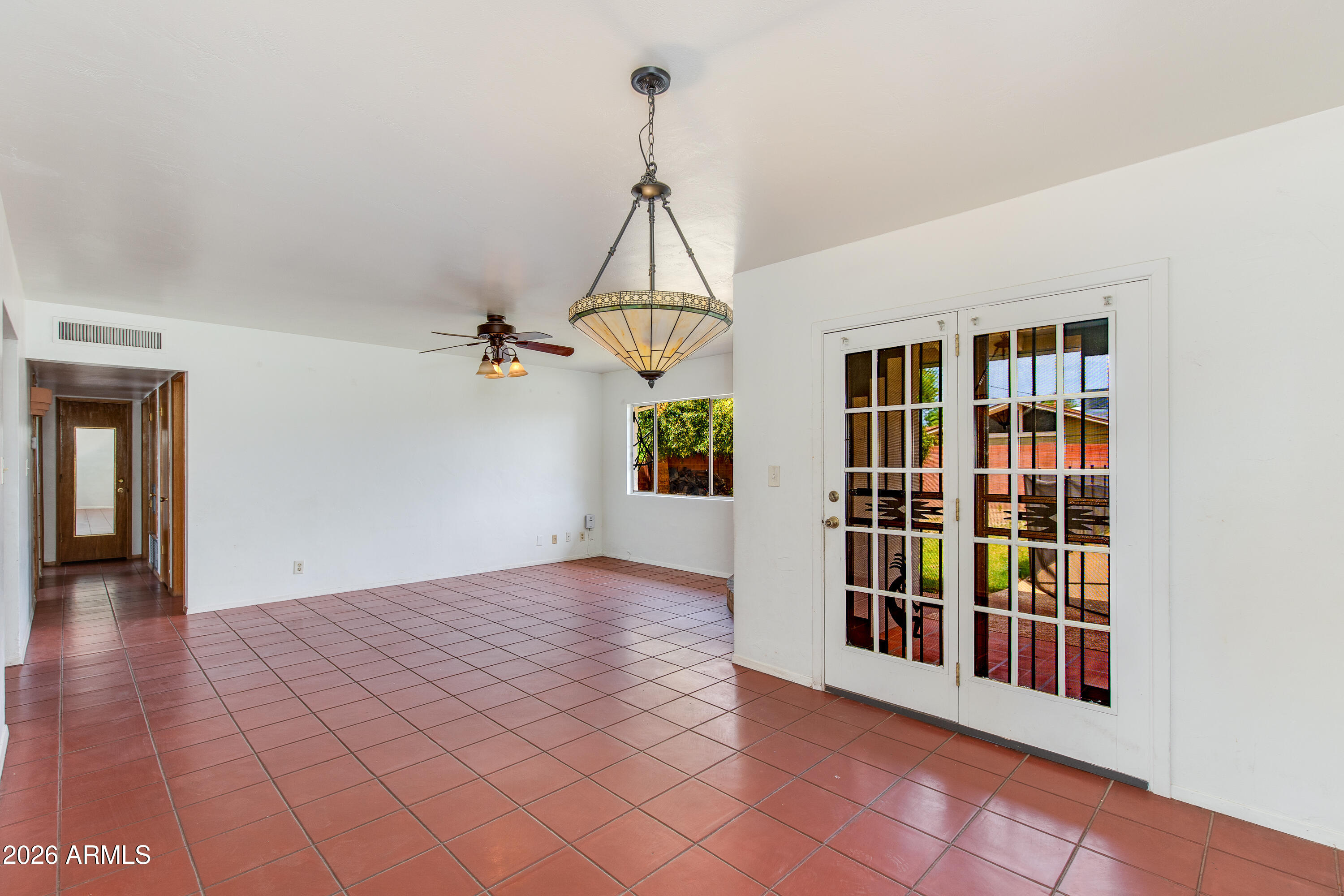 1524 West Ocotillo Road Phoenix, AZ 85015 - Photo 9 of 29 a view of an empty room with window and wooden floor