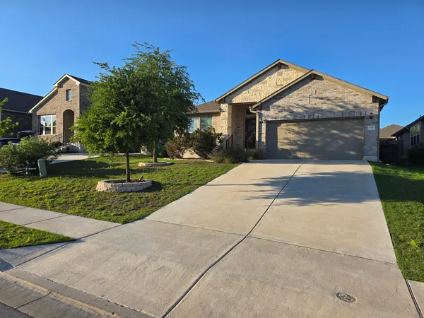a front view of house with yard and green space