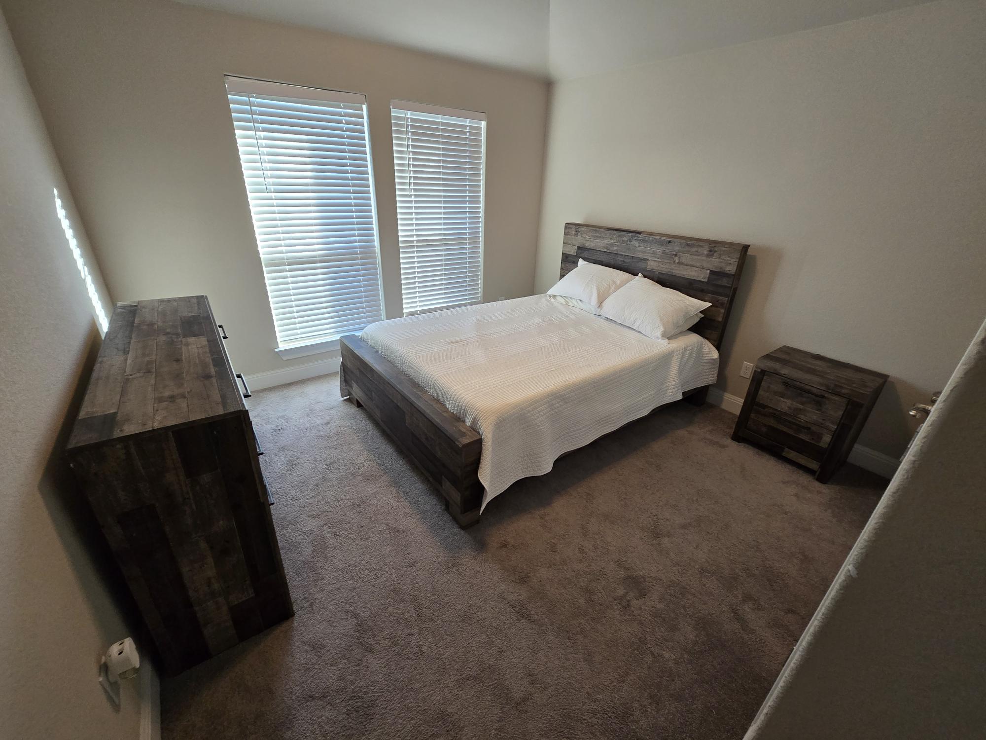 539 Tanda Lane Hutto, TX 78634 - Photo 12 of 18 a bed sitting in a bedroom next to a window