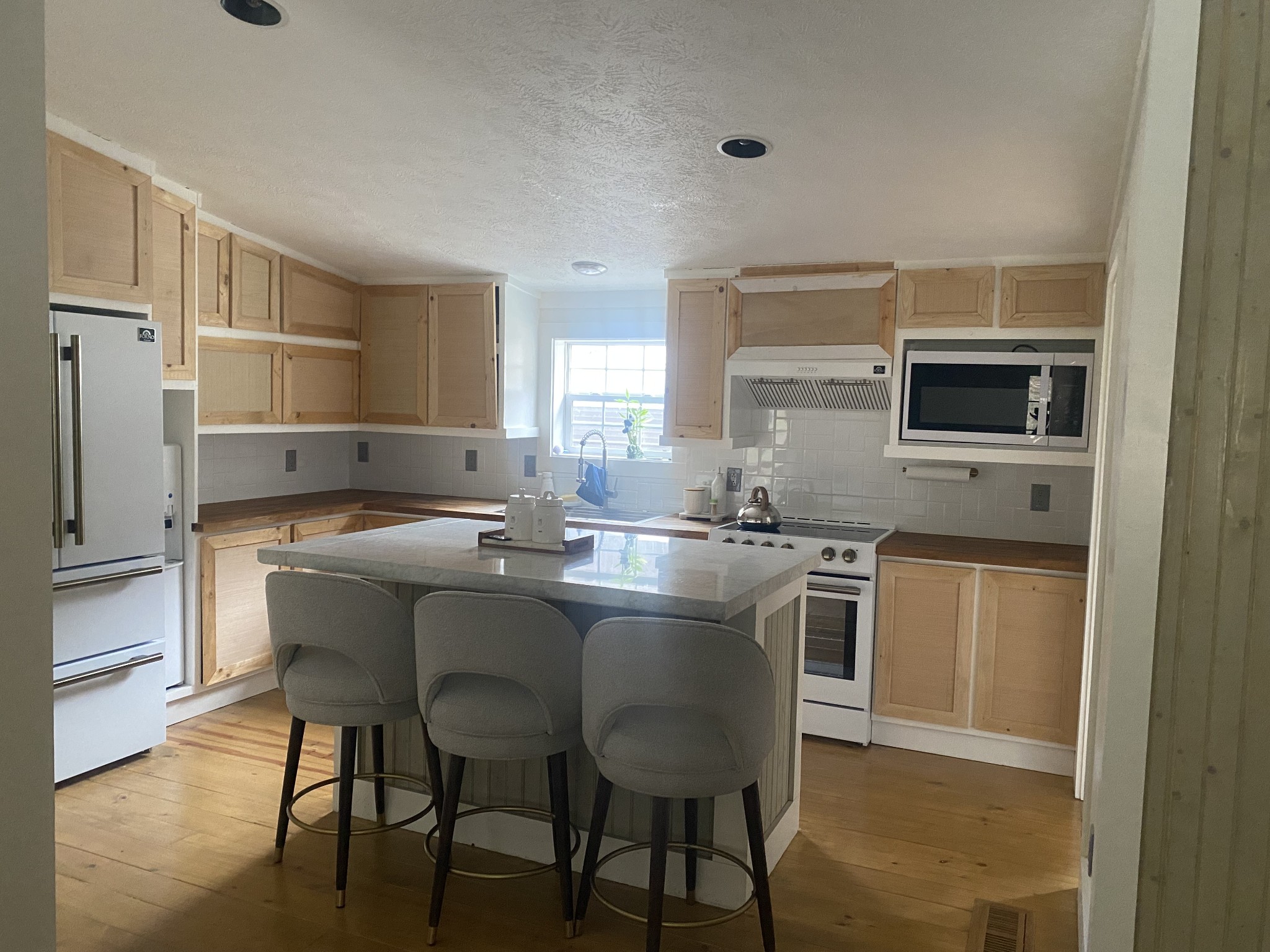 655 Wilmore Hollow Road Pleasant Shade, TN 37145 - Photo 10 of 47 a kitchen with kitchen island a dining table chairs cabinets and stainless steel appliances